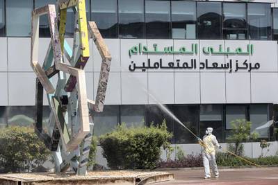DUBAI, UNITED ARAB EMIRATES. 08 APRIL 2020. A man sprays down the outside of the Dubai Municipality building in Al Quoz. (Photo: Antonie Robertson/The National) Journalist: Standalone. Section: National.