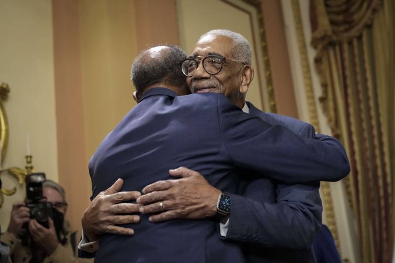 Radio host Joe Madison hugs Representative Bobby Rush  as they arrive for a bill enrolment ceremony for the Emmett Till Antilynching Act in Washington. Getty Images / AFP