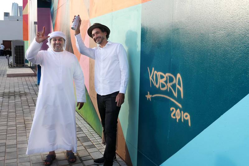 Kobra, with Mohamed Al Khadar, executive director of the strategic affairs sector at the DMT. Courtesy Department of Municipalities and Transport