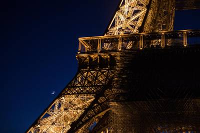 The waxing crescent moon rises during the last night of Eid Al Fitr at the Eiffel Tower in Paris. EPA