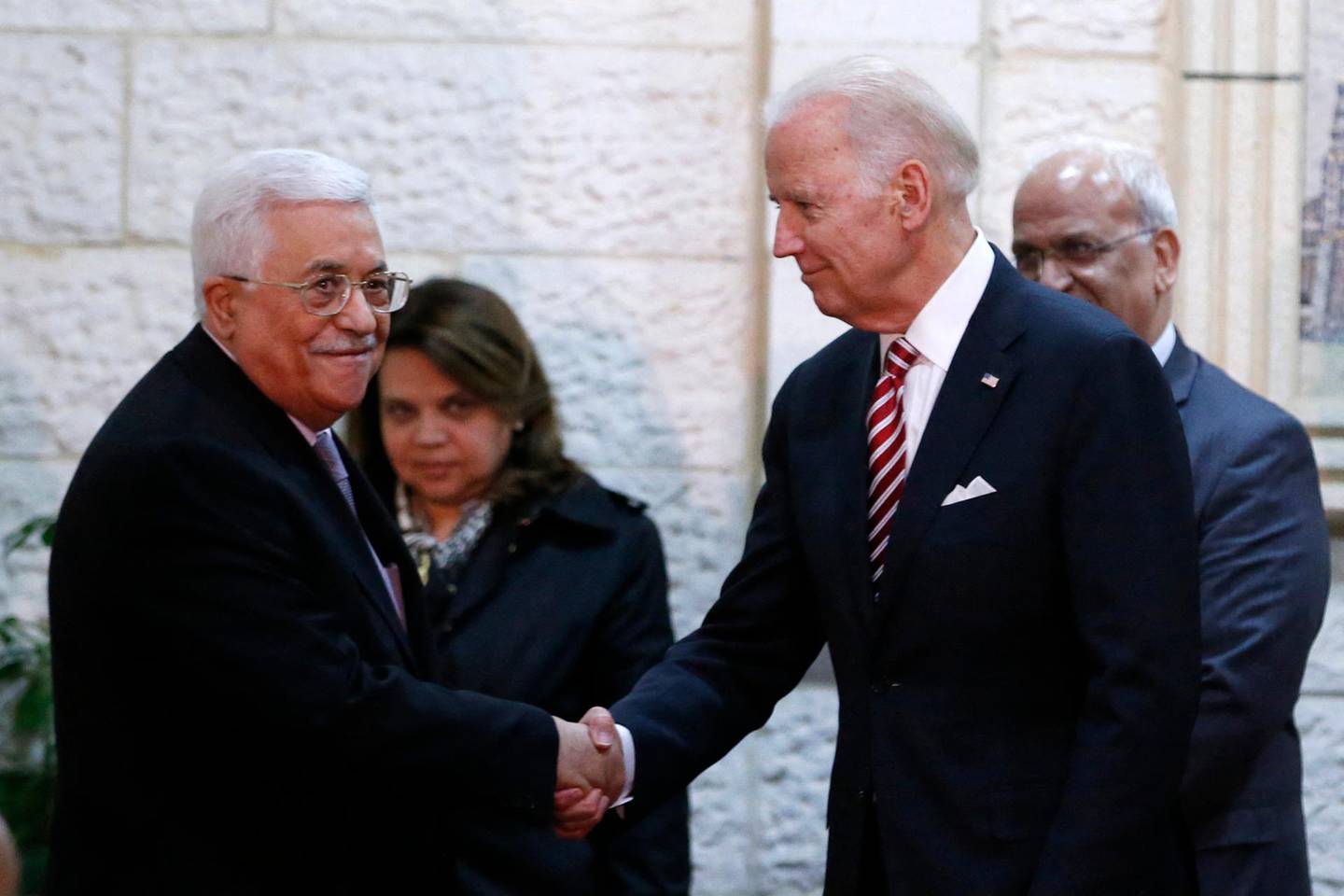 US Vice President Joseph Biden (R) shakes hands with Palestinian president Mahmud Abbas as they arrive for a meeting in the West Bank city of Ramallah on March 9, 2016. - Six separate attacks took place shortly before or after Biden's arrival the day before, including a stabbing spree on Tel Aviv's waterfront by a Palestinian who killed an American tourist and wounded 12 other people. (Photo by ABBAS MOMANI / AFP)