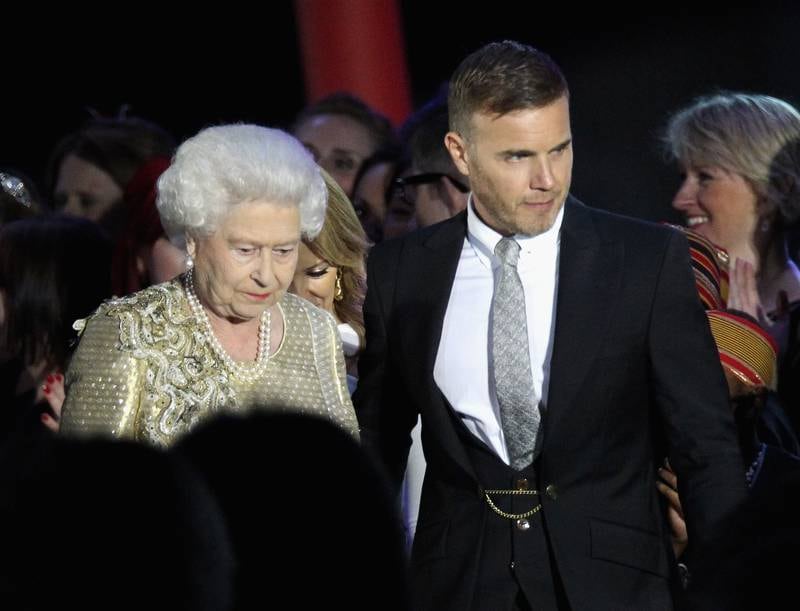 Queen Elizabeth and former Take That frontman Gary Barlow on stage as part of her diamond jubilee concert at Buckingham Palace in 2012. Getty Images