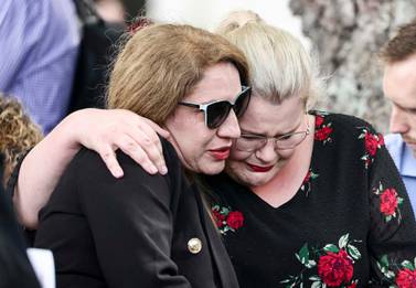 Two women embrace at the 10th anniversary memorial service of the Christchurch earthquake in Christchurch, New Zealand, on February 22, 2021. The 2011 earthquake killed 185 people. NZ Herald via AP