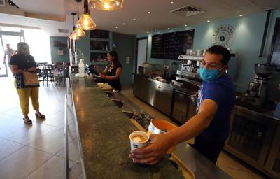 A waiter prepares coffee at a cafe which reopened for take away only in Tunis, Tunisia. EPA