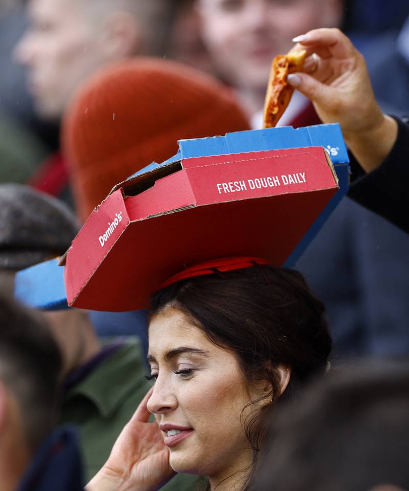 The Cheltenham Festival continued on Wednesday, with one race goer styled pizza boxes as a hat. Reuters