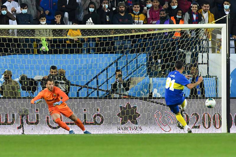 Boca Juniors players Cristian Pavon scores past Barcelona goalkeeper Neto during the penalty shootout at the Maradona Cup at the Mrsool Park Stadium in the Saudi capital Riyadh. AFP