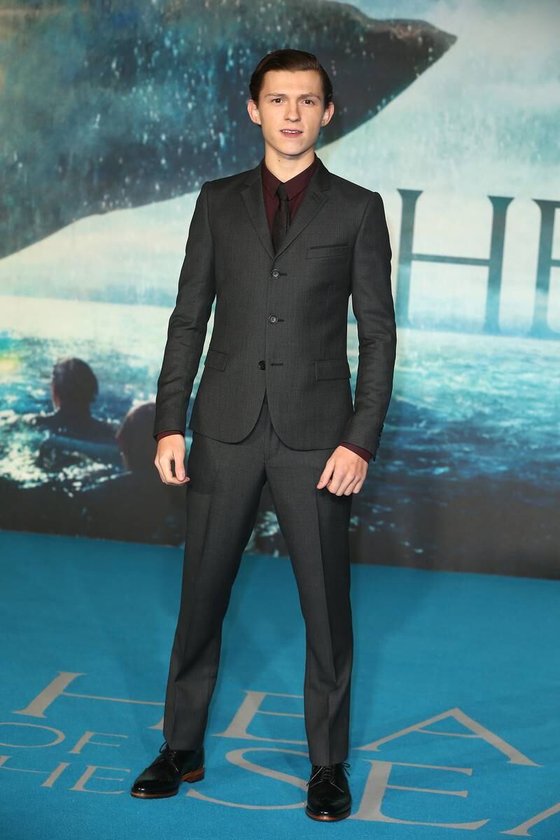 Tom Holland, in a grey Joshua Kane suit and claret shirt, attends the 'In The Heart Of The Sea' London premiere on December 2, 2015. Getty Images
