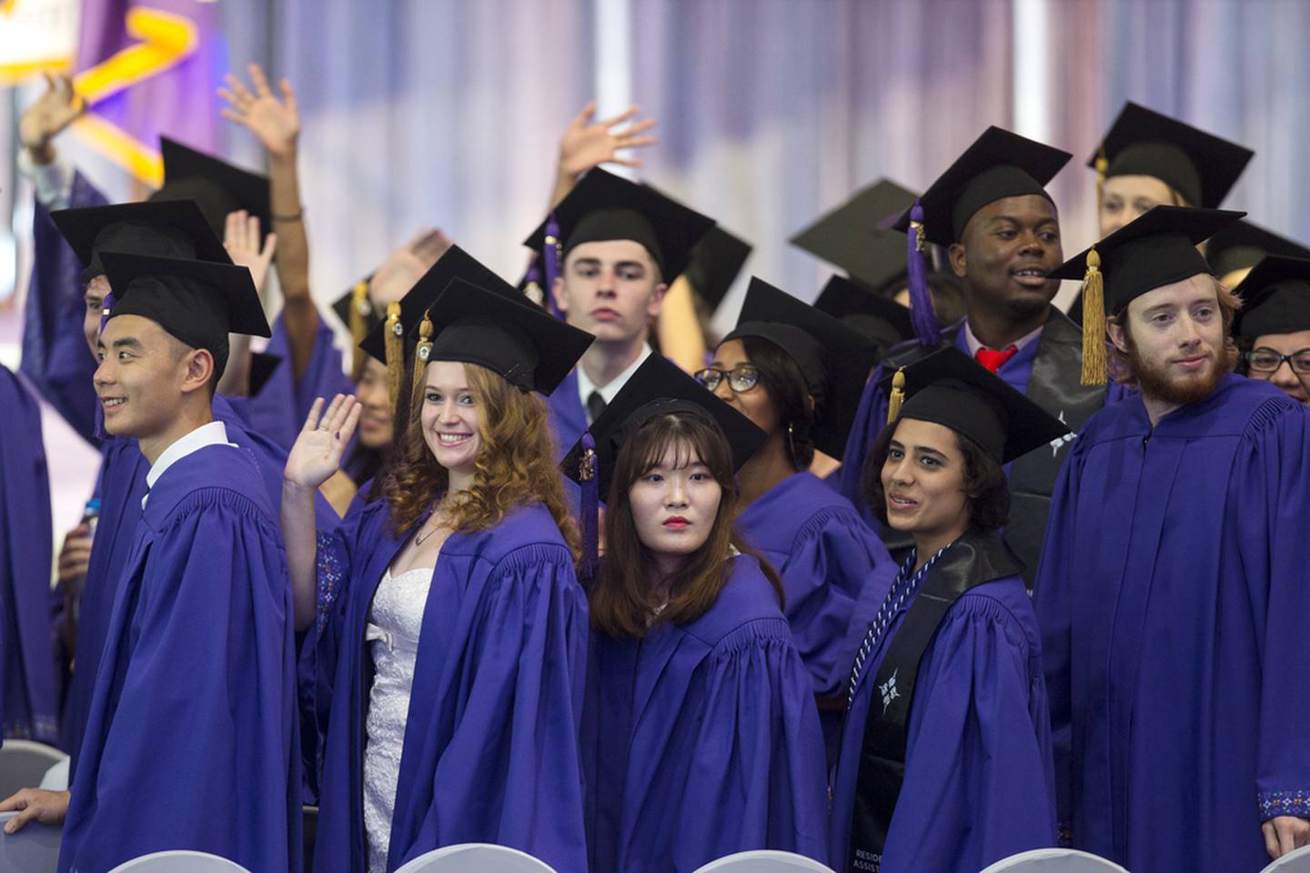 NYUAD students wave to friends and family during the graduation ceremony. Christopher Pike / The National