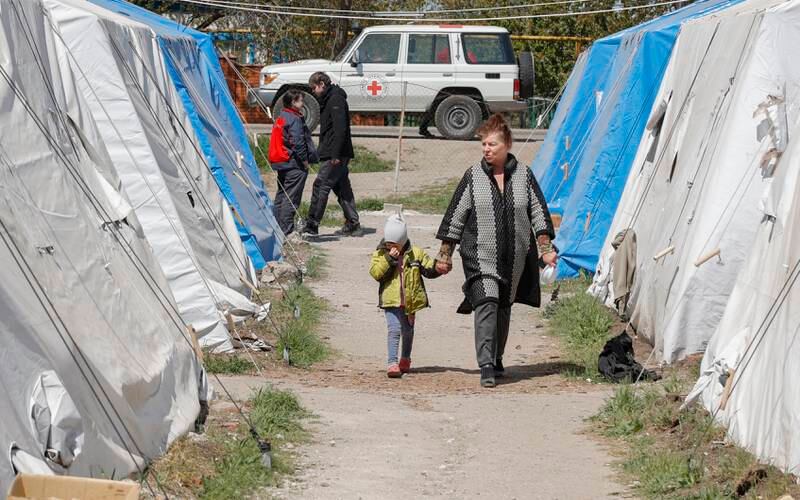 Civilians who were evacuated from Azovstal, walk in the temporary accommodation centre in Bezimenoye village, near Mariupol. EPA