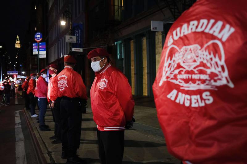 Members of the Guardian Angels, a volunteer organisation of unarmed citizens which began in the late 1970s, stand guard near looted stores during a night of protests and vandalism over the death of George Floyd, in New York City. Getty