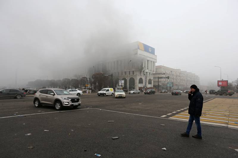 Smoke billows from the Kazakhstan state TV channel building, which was torched during protests in Almaty. Reuters