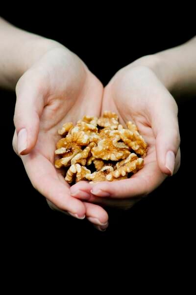 Handful of Walnuts --- Image by © Elisa Lazo de Valdez/Corbis