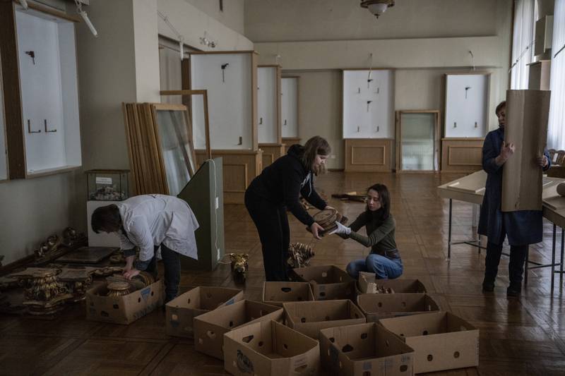 Workers and volunteers at the Andrey Sheptytsky National Museum store Baroque pieces in cardboard boxes, as part of safety preparations, in the event of an attack in the western Ukrainian city of Lviv.