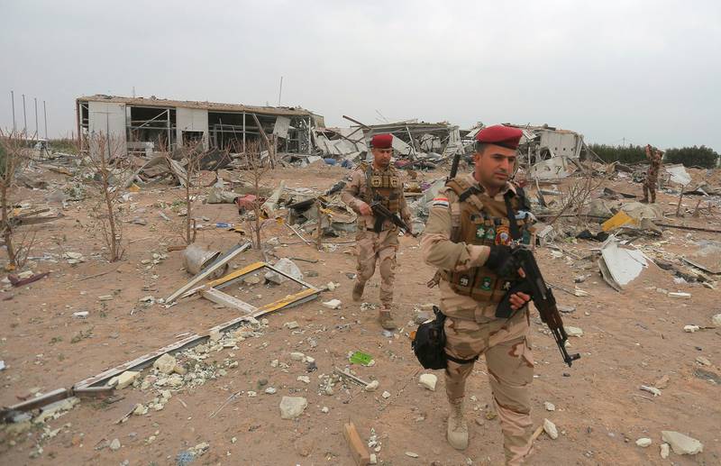 Iraqi army soldiers inspect the destruction at an airport complex under construction in Karbala. AP
