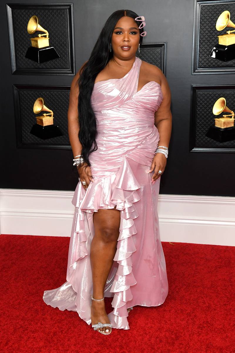 Lizzo in a one-strap pink ruffled gown by Balmain at the Grammy Awards on March 14, 2021. AFP