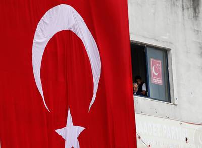 A Turkish flag hangs from a building during an election rally of Turkey's President Recep Tayyip Erdogan and his ruling Justice and Development Party, or AKP, in Istanbul, Turkey, on June 23, 2018. Lefteris Pitarakis / AP Photo