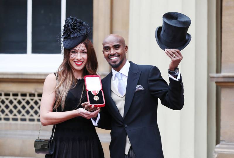 Farah with wife Tania after he was awarded a Knighthood by Queen Elizabeth II at Buckingham Palace, in 2017. PA
