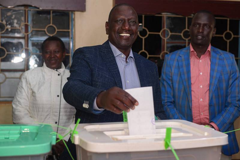 Kenya's Deputy President and presidential candidate of the Kenya First political party coalition William Ruto, centre, casts his ballot at a polling station in Sugoi, near Eldoret. AFP