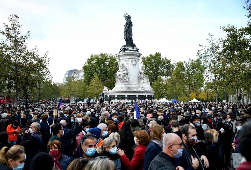People gather on Place de la Republique in Paris  in homage to history teacher Samuel Paty two days after he was beheaded by an attacker who was shot dead by policemen.  AFP
