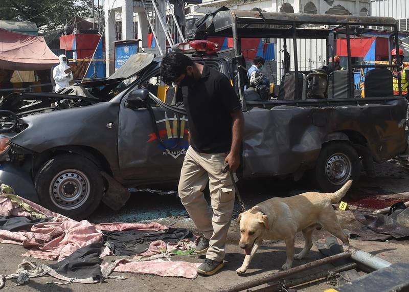 Officials examine the site of the bomb blast. AFP