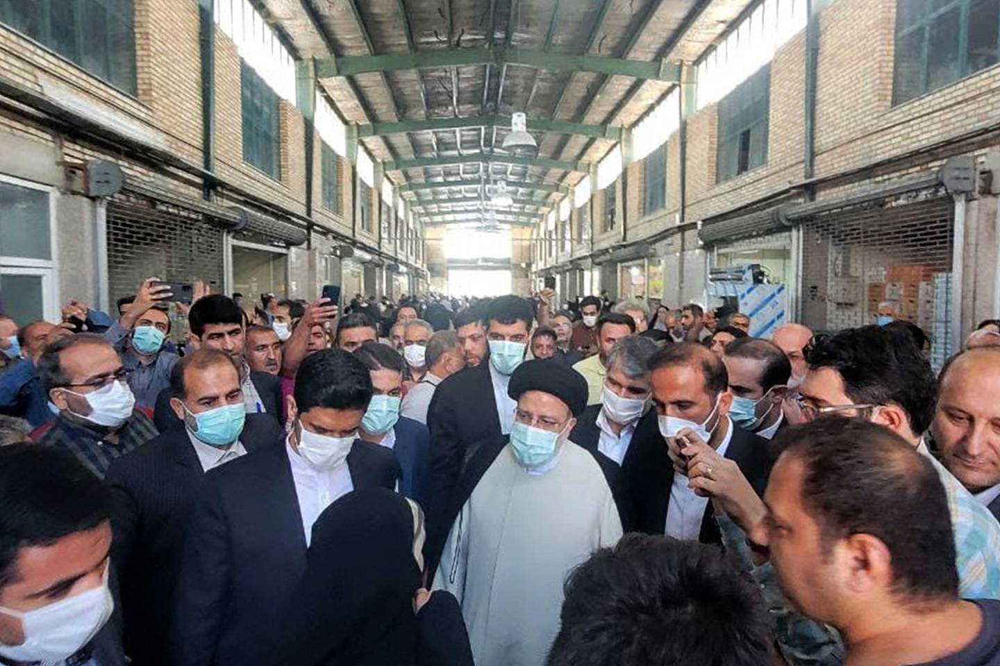 President Ebrahim Raisi (C) visiting a market in the capital Tehran, as prices of basic goods in Iran soar. Photo: Iranian Presidency 
