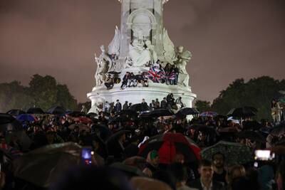 People gather at the Queen Victoria Memorial opposite Buckingham Palace on Thursday night after the death of Queen Elizabeth II. Reuters