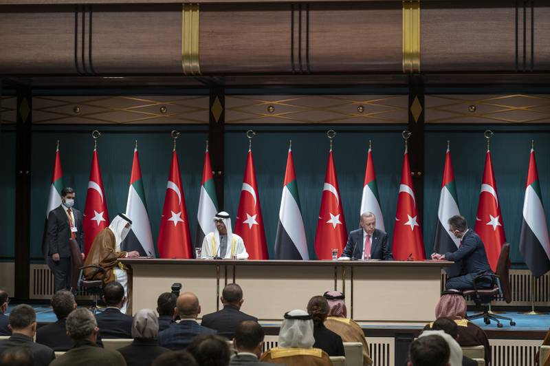 Sheikh Mohamed and Mr Erdogan witness the signing of an agreement by Ali Baalawi, head of the UAE Financial Intelligence Unit, and Hayrettin Kurt, head of the Financial Crimes Investigation Board of Turkey. Mohamed Al Hammadi / Ministry of Presidential Affairs