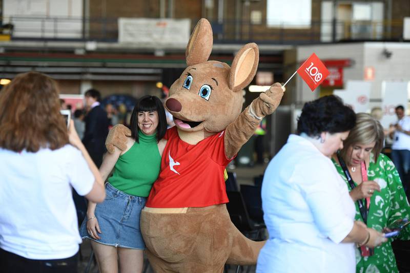 Visitors pose for photos with a kangaroo mascot. EPA