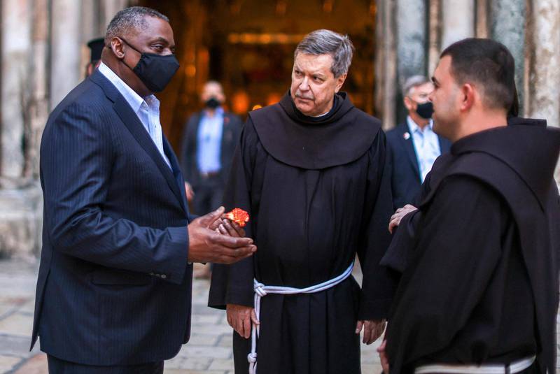 US Defence Secretary Lloyd Austin speaks with Franciscan monks outside the Church of the Holy Sepulchre in Jerusalem's Old City, during his visit to Jerusalem. AFP