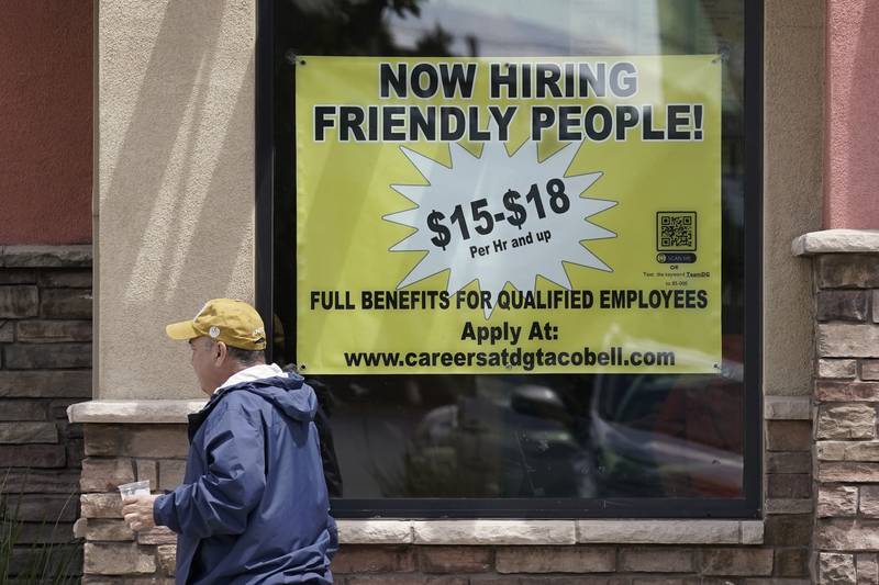 Starting wages are advertised on a sign in the window of a Taco Bell in Sacramento, California. AP