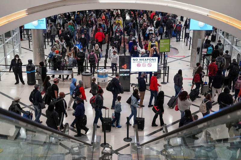 Travellers queue outside the security checkpoint  at Hartsfield-Jackson Atlanta International Airport in Georgia, US, as the Omicron variant spurs a rise in case numbers in many countries. Reuters