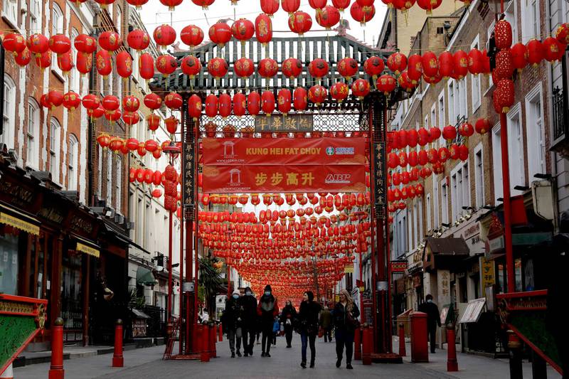 People walk beneath lanterns hung across the street to celebrate the Chinese Lunar New Year which marks the Year of the Ox, in the Chinatown district of central London. AP Photo