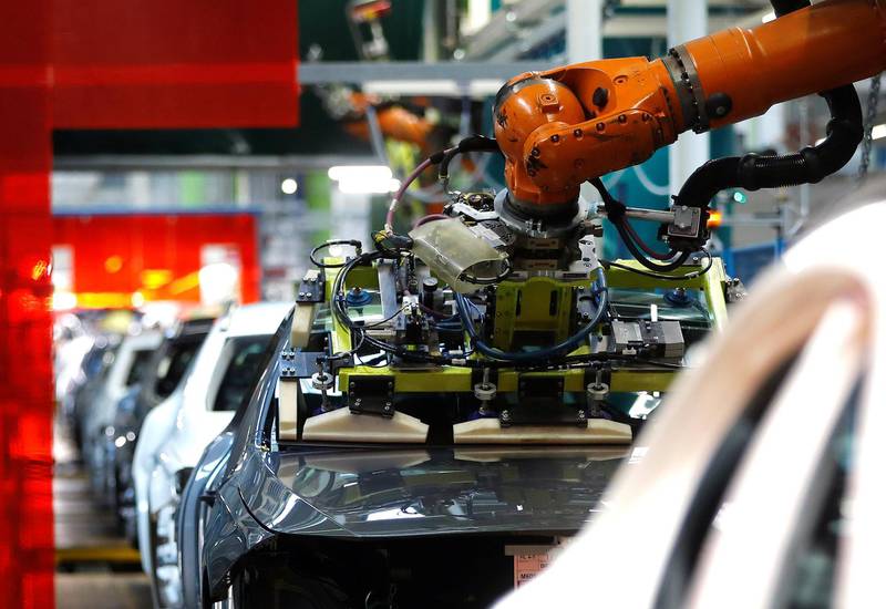 A robot engineered by Kuka adjusts a windscreen in a fully automated process on a model of the A-class production line of German car manufacturer Mercedes Benz at the Daimler factory in Rastatt, Germany, February 4, 2019. Picture taken on February 4, 2019.  REUTERS/Kai Pfaffenbach