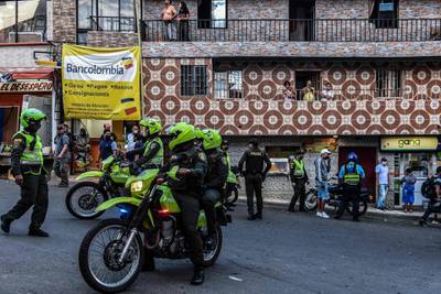 Police officers are seen during a raid at Santo Domingo neighborhood amid the new COVID-19, coronavirus pandemic, in Medellin, Colombia.  AFP