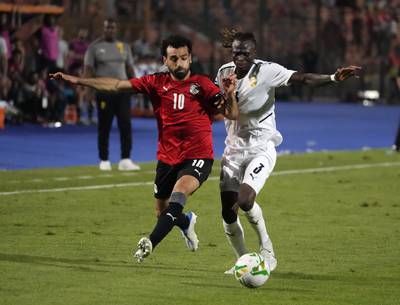 Egypt's Mohamed Salah, left, fights for the ball with Guinea's Issiaga Sylla during their soccer match in Group D 2023 Cup of Nations (AFCON) qualifiers at Cairo International stadium in Cairo, Egypt.  Egypt won 1-0. AP Photo