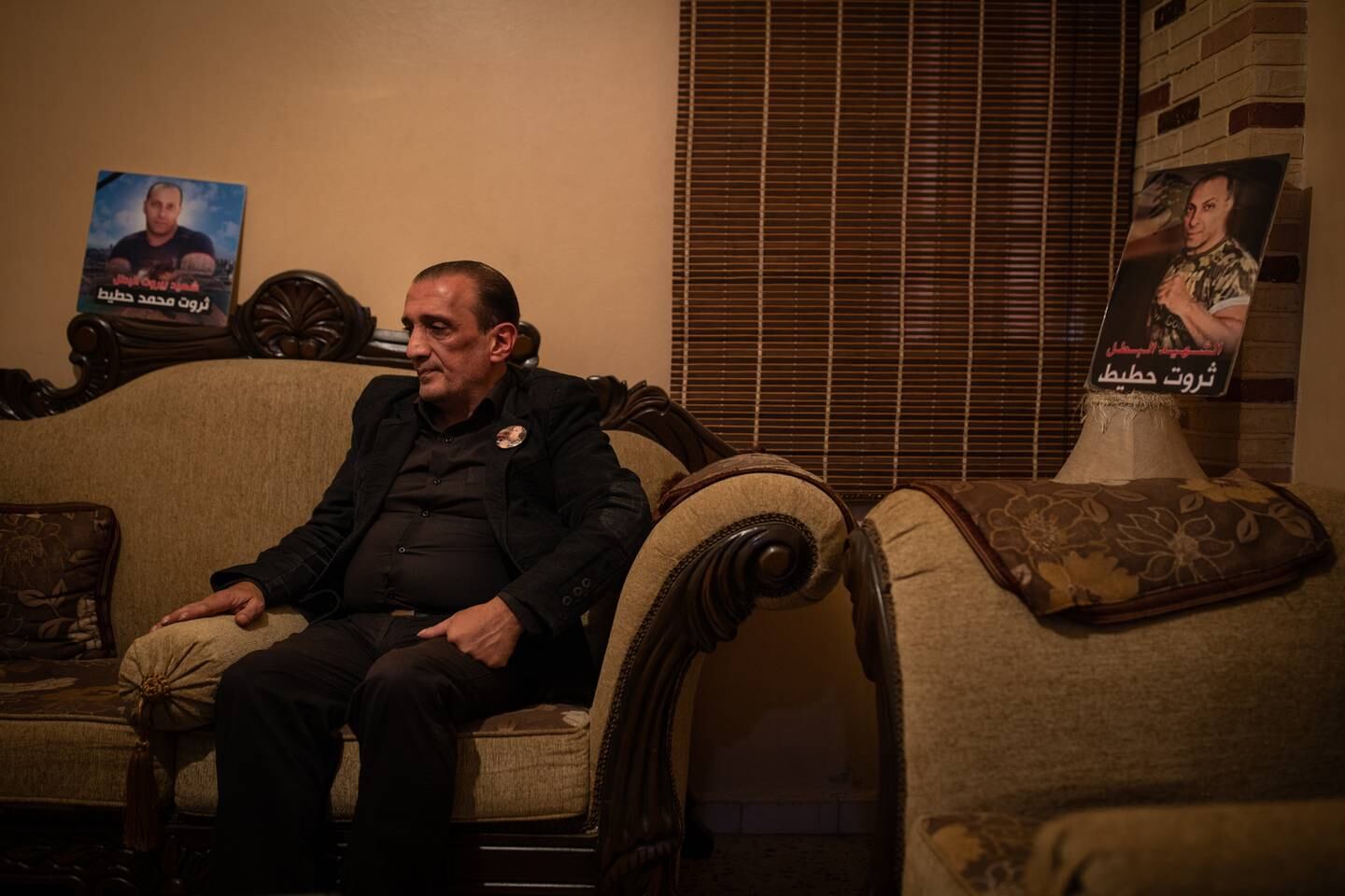 LEBANON: Monday 13 December 2021 Ibrahim Hoteit sits flanked by photos of his brother in his living room in Borj El Brajneh in the souther suburbs of Beirut.     Oliver Marsden for The National 