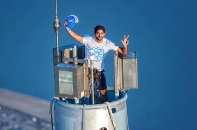 An image made available on November 28, 2013 by the personal photographer Sheikh Hamdan Bin Mohamed Bin Rashid al-Maktoum, shows Dubai's Crown Prince Sheikh Hamdan, gesturing as he wears a t-shirt bearing the logo of Dubai's 2020 World Expo campaign on top of Burj Khalifa, the world's tallest tower on November 25, 2013 to mark the emirates 42nd independence day and as part of a campaign that Dubai launched to win the 2020 World Expo. Dubai beat off opposition from Brazil, Russia and Turkey on November 27, to win the right to host the 2020 World Expo, sparking celebrations in the Gulf city and a stunning fireworks display at the world's tallest building. AFP PHOTO/HO/ALI ISSA-PERSONAL PHOTOGRAPHER OF SHIEKH HAMDAN BIN MOHAMED BIN RASHID AL-MAKTOUM   == RESTRICTED TO EDITORIAL USE - MANDATORY CREDIT "AFP PHOTO / ALI ISSA-PERSONAL PHOTOGRAPHER OF SHIEKH HAMDAN BIN MOHAMED BIN RASHID AL-MAKTOUM" - NO MARKETING NO ADVERTISING CAMPAIGNS - DISTRIBUTED AS A SERVICE TO CLIENTS == (Photo by ALI ISSA / ALI ISSA / AFP)