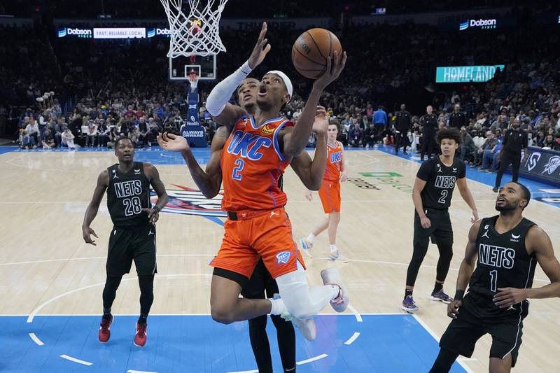 Oklahoma City Thunder's Shai Gilgeous-Alexander, whose plays you can collect via NBA NFTs, scores against the Brooklyn Nets. Photo: AP 