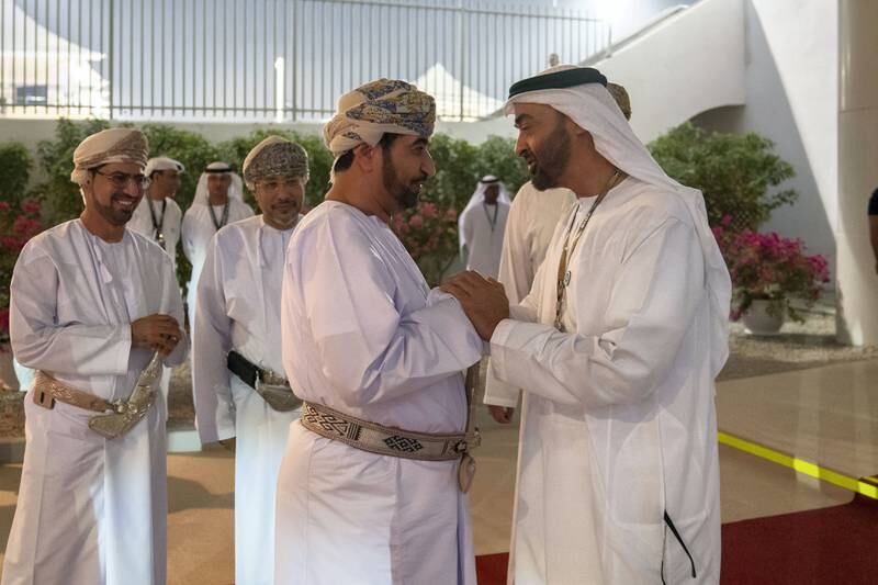 ABU DHABI, UNITED ARAB EMIRATES - November 25, 2018: HH Sheikh Mohamed bin Zayed Al Nahyan, Crown Prince of Abu Dhabi and Deputy Supreme Commander of the UAE Armed Forces (L) greets HE Sayyid Khalid Bin Hilal Al Busaidi, Minister of Diwan of Royal Court of Oman (2nd L), on the final day of the 2018 Formula 1 Etihad Airways Abu Dhabi Grand Prix, in Shams Tower.

( Mohamed Al Hammadi / Ministry of Presidential Affairs )
---