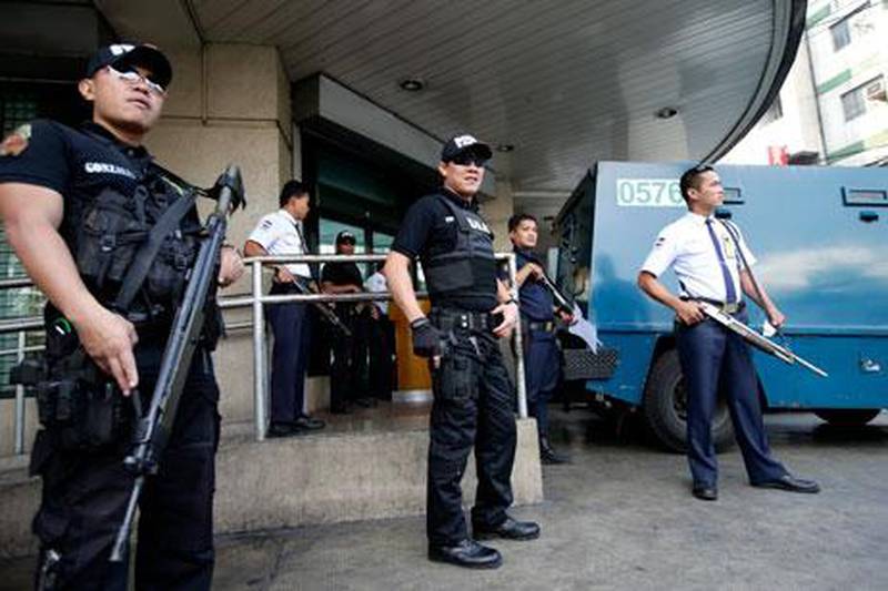 Members of the Philippine national police Swat team patrol a bank in Manila on Friday. Bullit Marquez / AP Photo