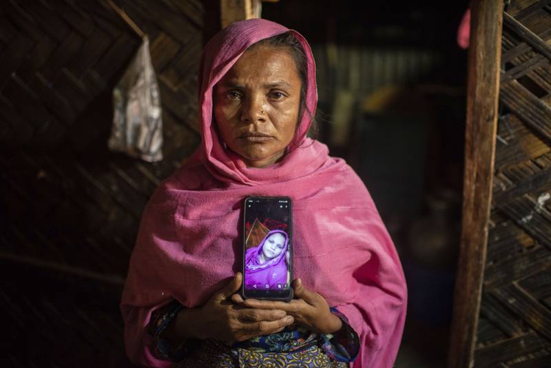 Hasina Khatun shows a photo of her daughter Asma Bibi, 18, who was heavily pregnant when she and her younger brother fled Bangladesh in December and boarded a boat bound for Indonesia, which went missing. AP