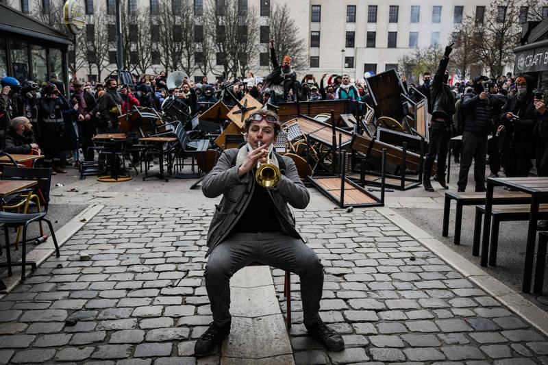 A trumpet-playing protester in Lyon, France, amid rallies over pension reform.  AFP