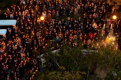 People attend a candlelight vigil remembering the victims of the attack in Vienna, Austria. AFP