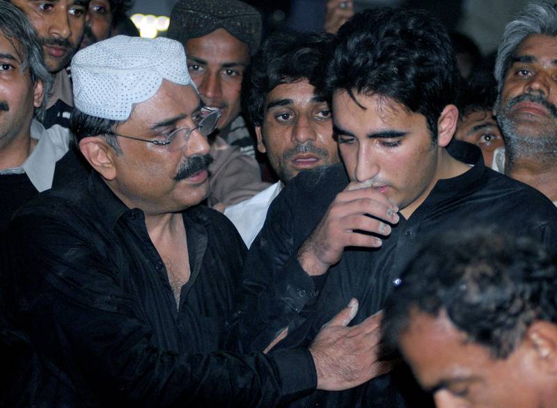 Asif Ali Zardari comforts his son Bilawal after Benazir Bhutto's funeral in the village of Ghari Khuda Baksh on December 28, 2007. Mr Bhutto Zardari, then 19, assumed leadership of the Pakistan Peoples Party after his mother's assassination. AFP
