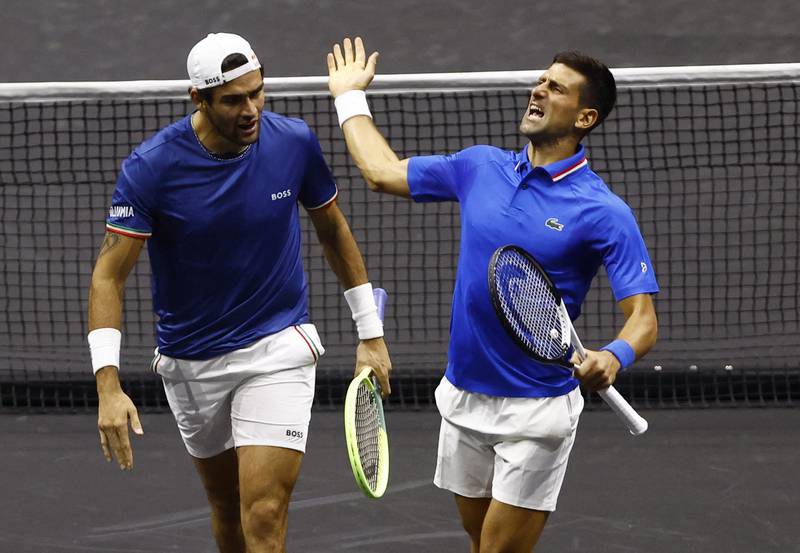 Novak Djokovic and Matteo Berrettini celebrate winning their doubles match against Team World's Alex de Minaur and Jack Sock. Reuters