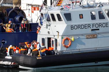 A Border Force boat carrying migrants arrives at Dover harbour in England. Reuters 