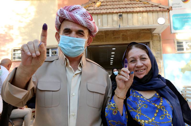 Voters display their inked fingers outside a polling station in Duhok. Photo: Reuters