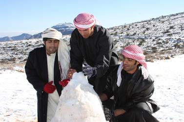Caption RAK Ras Al Khaimah, UAE: 25 JANUARY 2009: Snow covering the top of Jebel Jais Mountain and local men building a snow man during wintry weather in the Northern Emirate. Coutesy Mike Charlton??Object Name: Rating: ?Category: Copyright: ?Byline: Coutesy Mike Charlton Credit: ?Headline:
