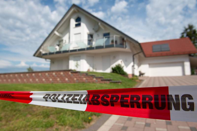 (FILES) This file photo taken on June 3, 2019 shows barrier tape of the police cordoning off the house of murdered city administrative chief Walter Luebcke in Wolfhagen near Kassel, central Germany. German prosecutors said on April 29, 2020 they had formally charged a known neo-Nazi with the June 2019 murder of a pro-refugee politician, the first in a string of recent far-right killings. Federal investigators said 45-year-old Stephan Ernst drove to Walter Luebcke's house in Wolfhagen near Kassel, on the evening of June 1, 2019 and crept up under cover of darkness to the terrace where Luebcke sat before shooting him in the head with a revolver. -  - Germany OUT
 / AFP / DPA / Swen Pförtner
