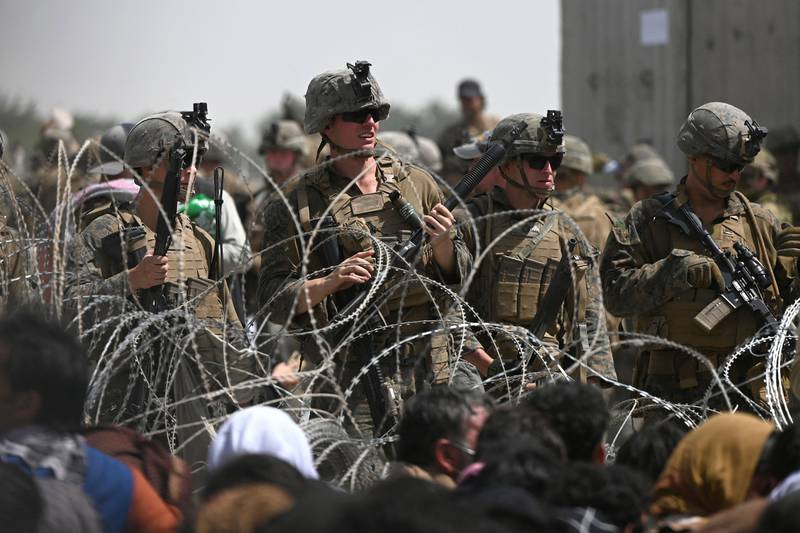 US soldiers stand guard near the military part of the airport in Kabul as Afghans attempt to flee the Taliban. AFP